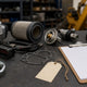 Generic construction equipment spare parts with a blank parts tag on a workshop desk